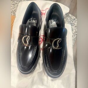 Christian Louboutin Shiny Black Loafers with Silver Accent .
